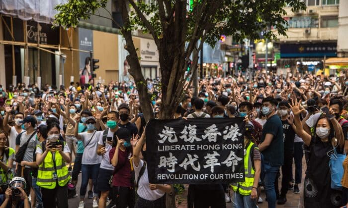 Демонстранти скандират по време на митинг на 1 юли 2020 г.срещу новия закон за националнатта сигурност на Пекин (Дейл де ла Рей/AFP via Getty Images)