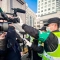 Полицай покрива медийна камера, за да попречи на журналистите да снимат пред новия Народен съд на район Пудун в Шанхай, където е насрочен процесът срещу китайската гражданска журналистка Джан Джан, 28 декември 2020 г. (Лео Рамирез /AFP via Getty Images)