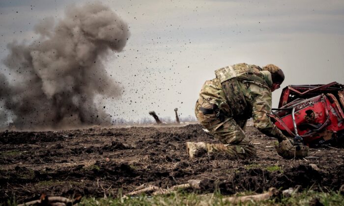 Украински военнослужещ заляга, след като е хвърлил граната по време на обучение в контекста на руската инвазия в Украйна, в региона Донбас, Украйна, на 8 април 2023 г. (Снимка: Ян Добронсов/Ройтерс)