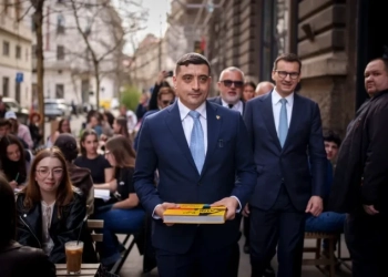 Джордже Симион, председател на партия AUR (Алианс за обединение на румънците), върви пред бившия полски премиер Матеуш Моравйецки (вдясно) в Букурещ на 14-ти март 2025 г. Снимка: Вадим Гирда/AP