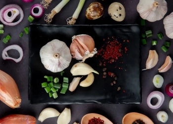top view plate vegetables as garlic cut scallion with onion egg spices moaoaroon background