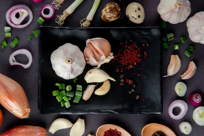 top view plate vegetables as garlic cut scallion with onion egg spices moaoaroon background